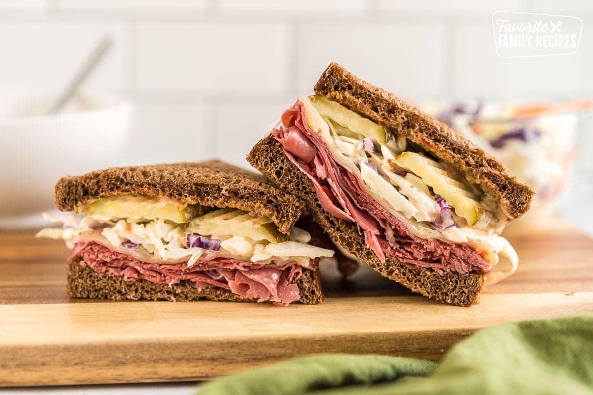 A corned beef sandwich sliced in half.