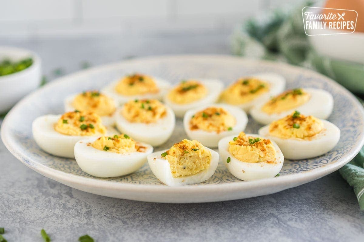 Deviled eggs on a plate with a bite taken out of one.