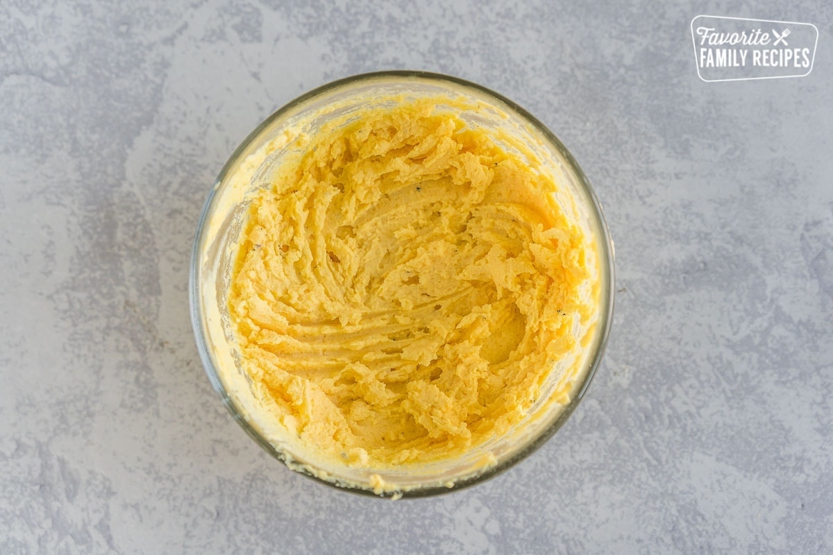 Filling for deviled eggs in a small bowl.