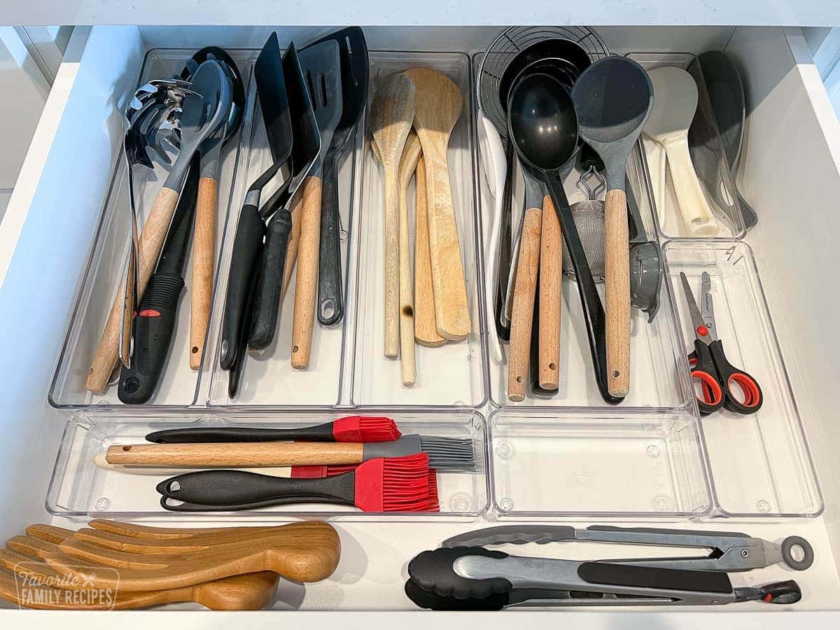 Cooking utensils organized in a drawer with drawer dividers