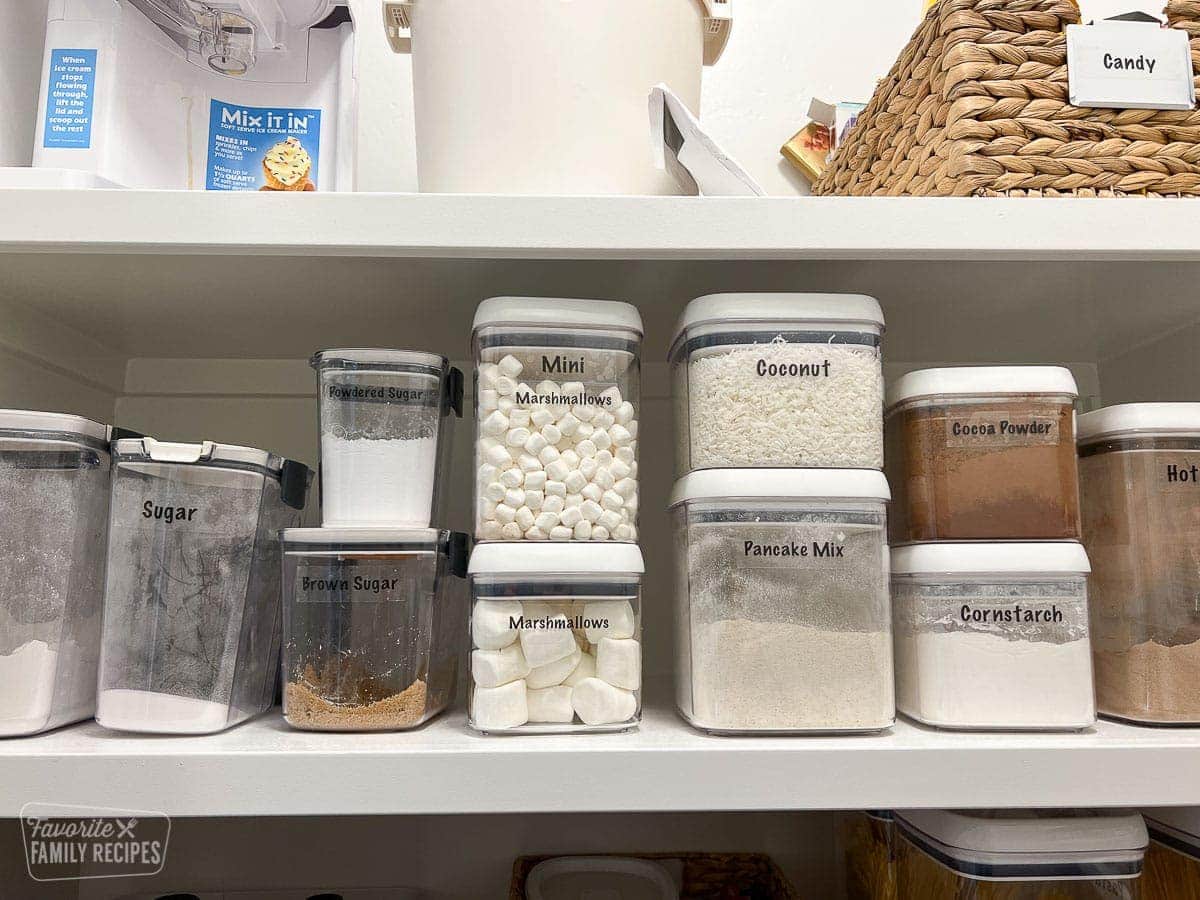 Baking ingredients such as flour, sugar, cornstarch etc... that have been decanted and organized in plastic containers