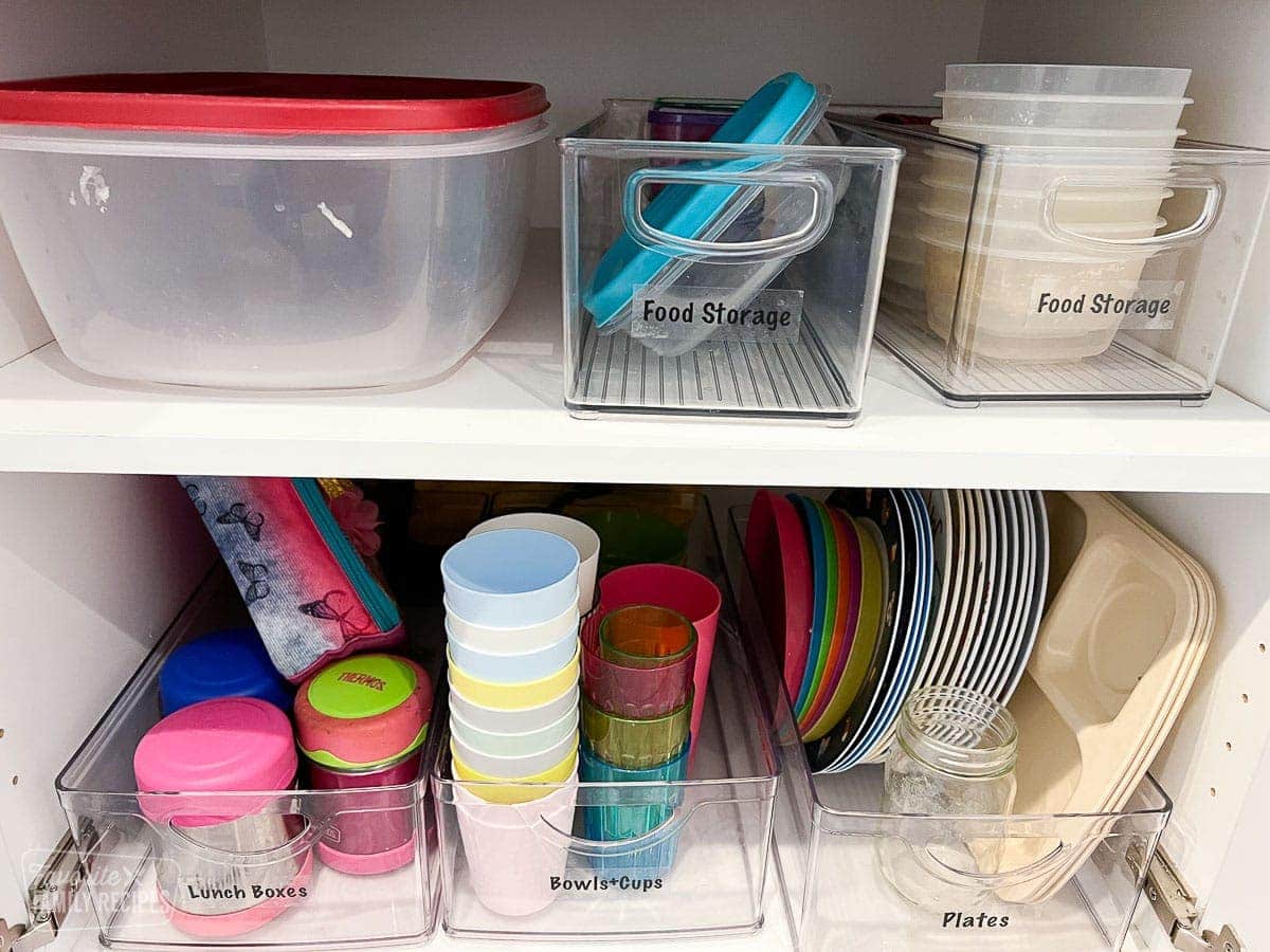 Kids cups and plates organized in a cupboard