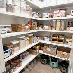 An organized kitchen pantry with bins and containers that are labeled identifying each ingredient