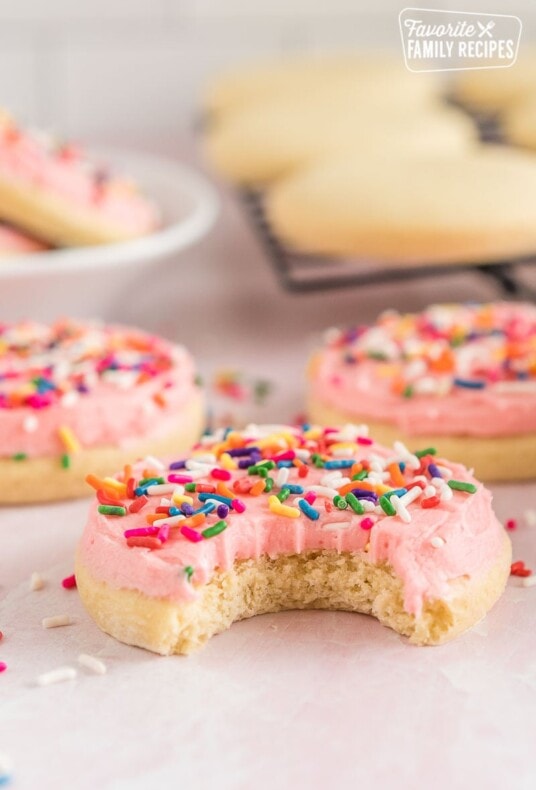 A big pink sugar cookie with a bite taken out