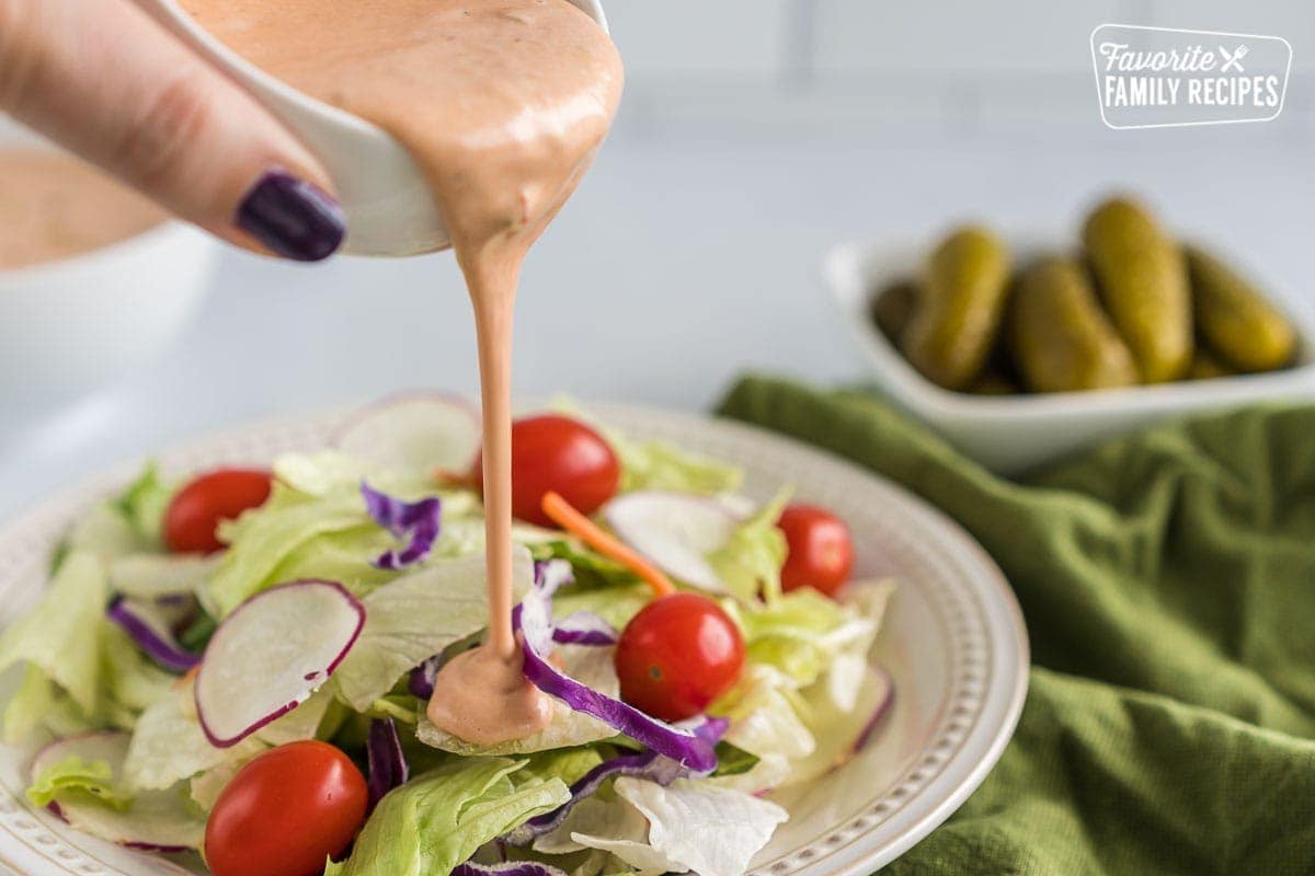 Russian Dressing being poured on a salad