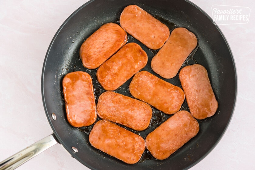 Cooking spam in a skillet.