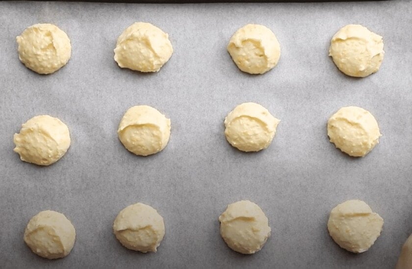 Brazilian cheese bread dough balls on a baking sheet