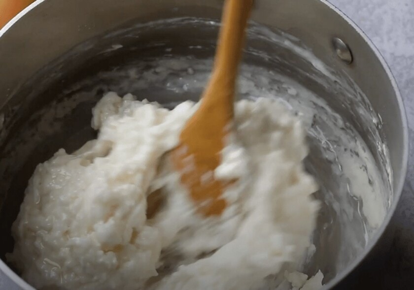 A mixing bowl with oil, milk, and tapioca flour being mixed together