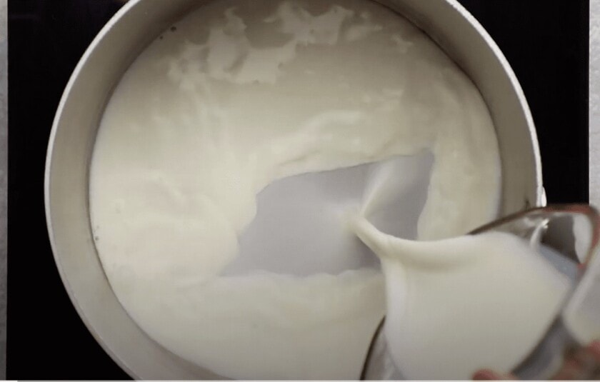 Milk being poured into a mixing bowl