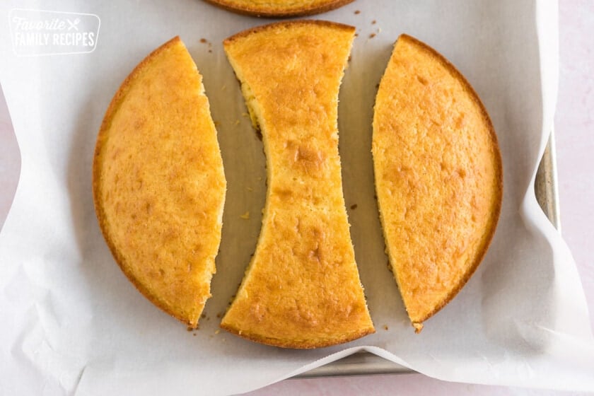 A round vanilla cake cut into two bunny ears and a bowtie