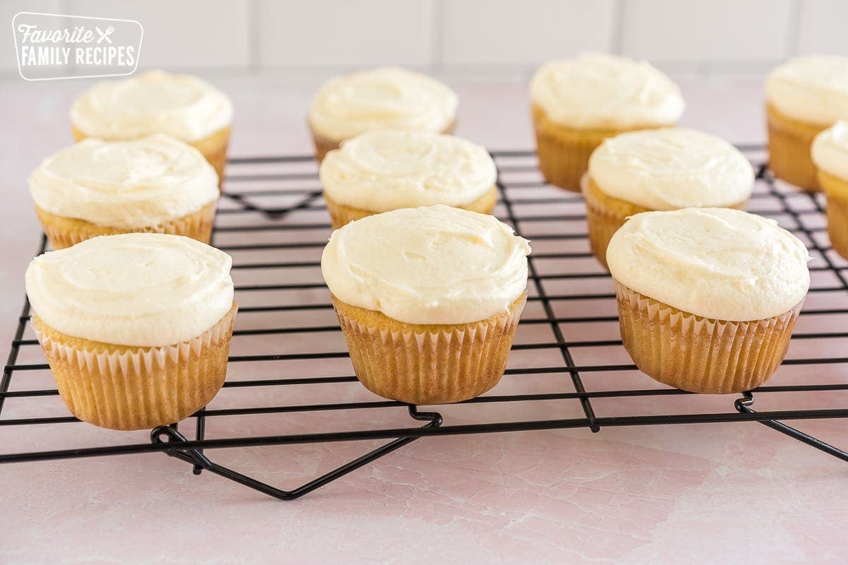 Coconut cupcakes topped with coconut cream cheese frosting