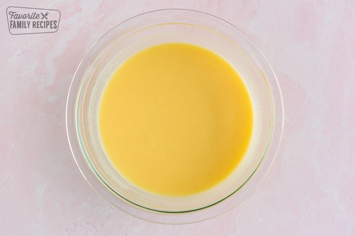 Vanilla pudding mix combined with milk in a large bowl
