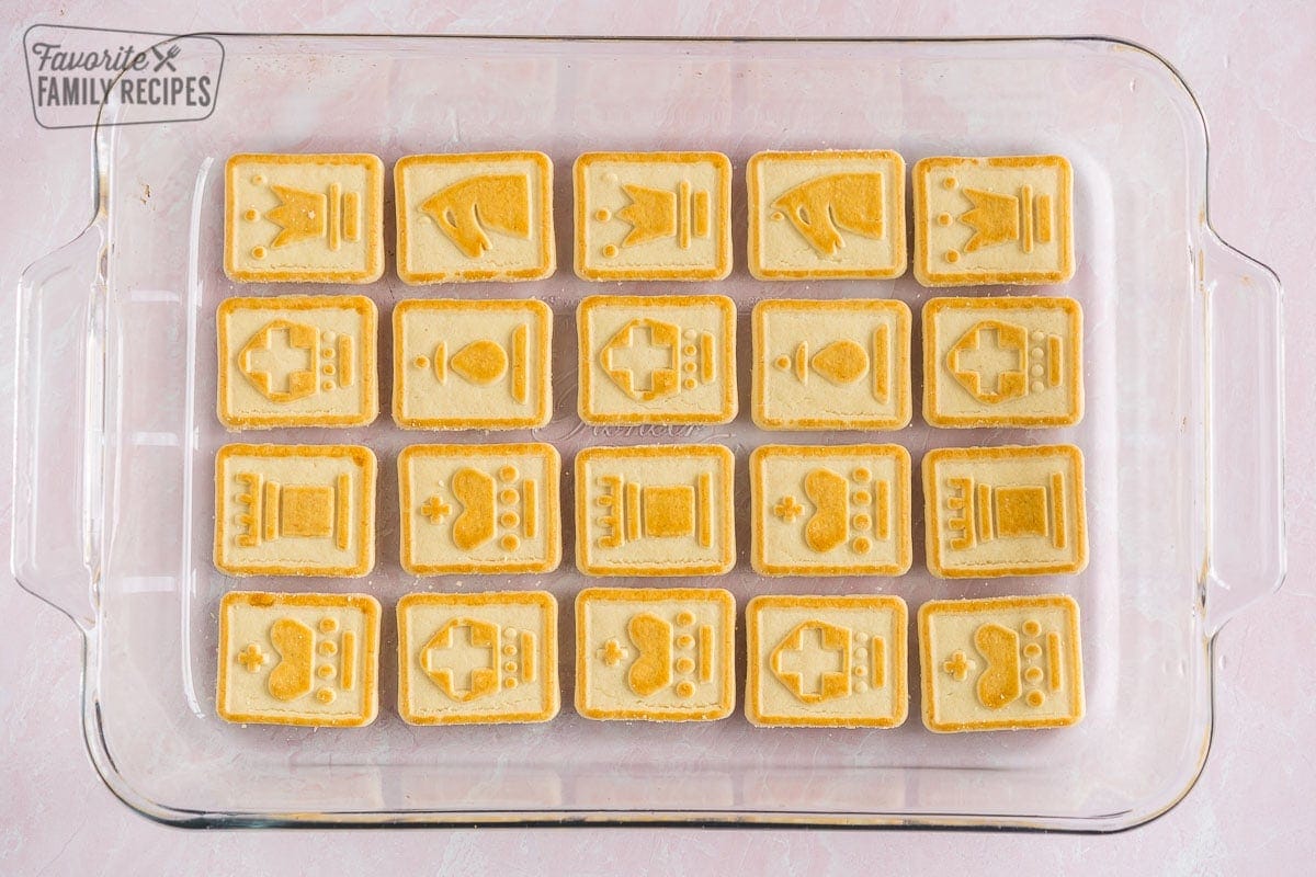 Chessman cookies laid out on the bottom of a glass baking dish