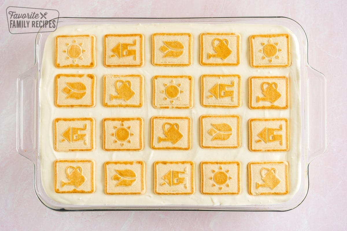 Banana pudding topped with Chessman cookies in a baking dish
