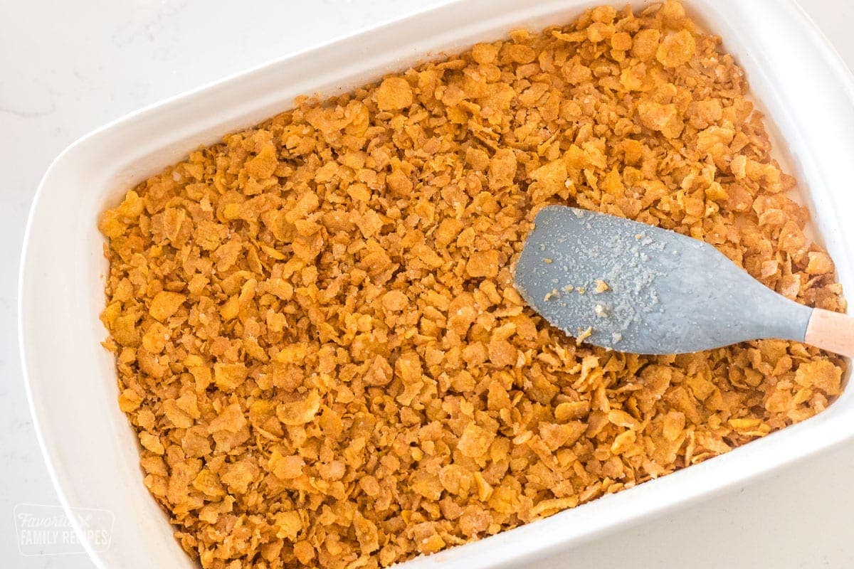 A 9x13 pan with ice cream and a corn flake topping over the top