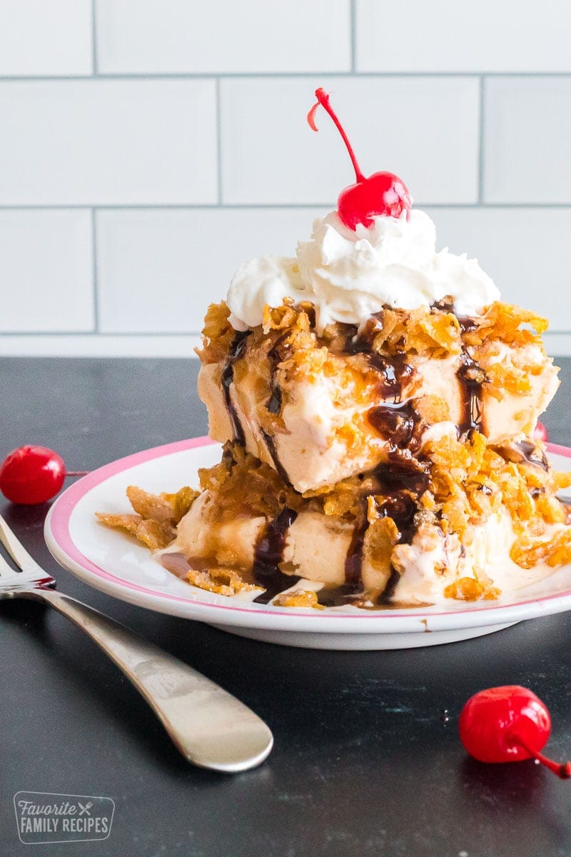 Fried ice cream with a sweet crunchy topping, whipped cream, chocolate, caramel, and a cherry on top