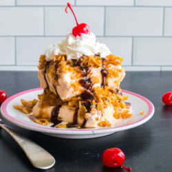 Fried ice cream with a crunchy corn flake topping surrounded by cherries