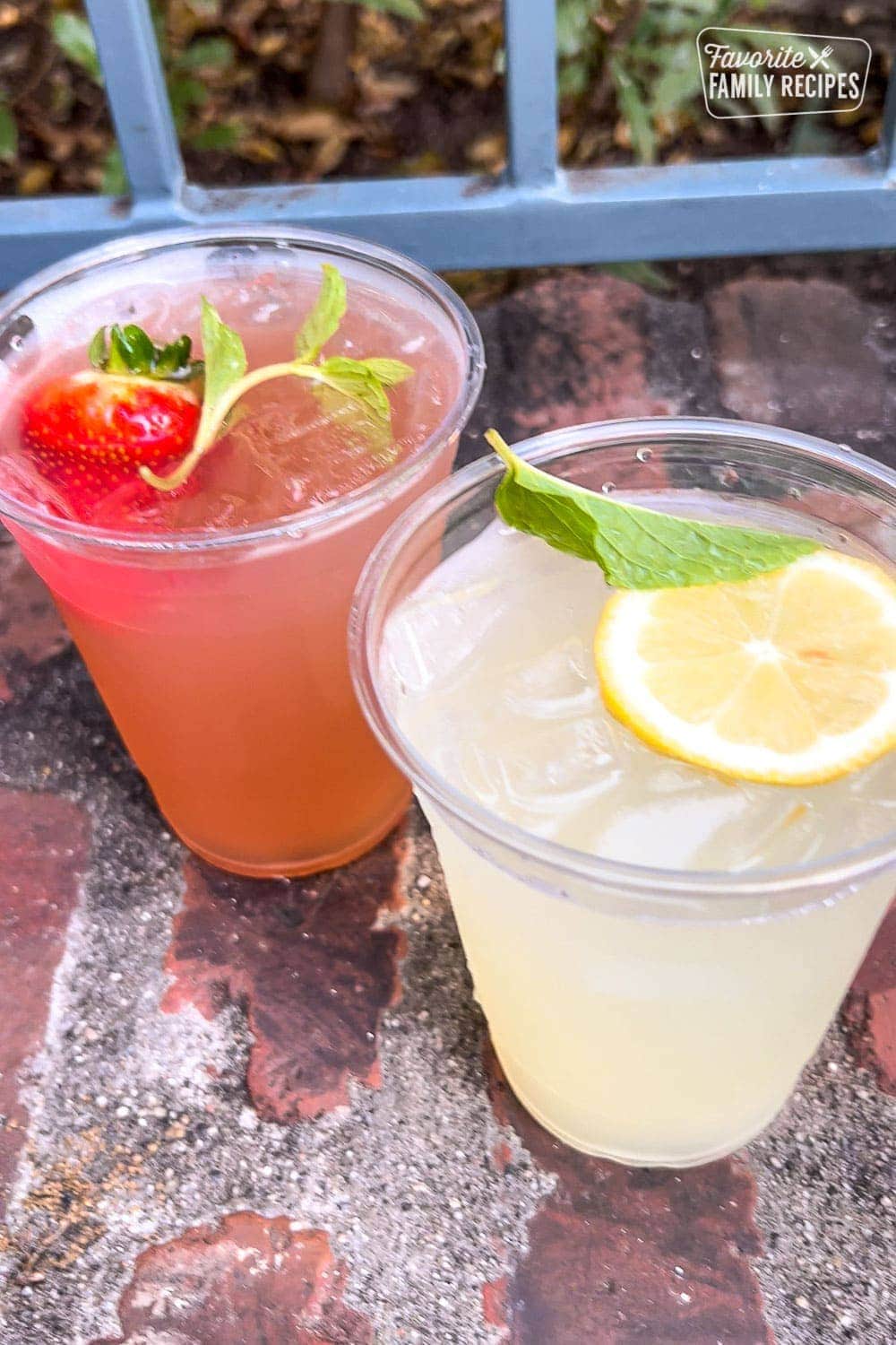 Two mint juleps in two cups next to each other. 