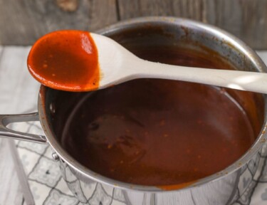 Sauce Pan of homemade BBQ Sauce on a pot holder