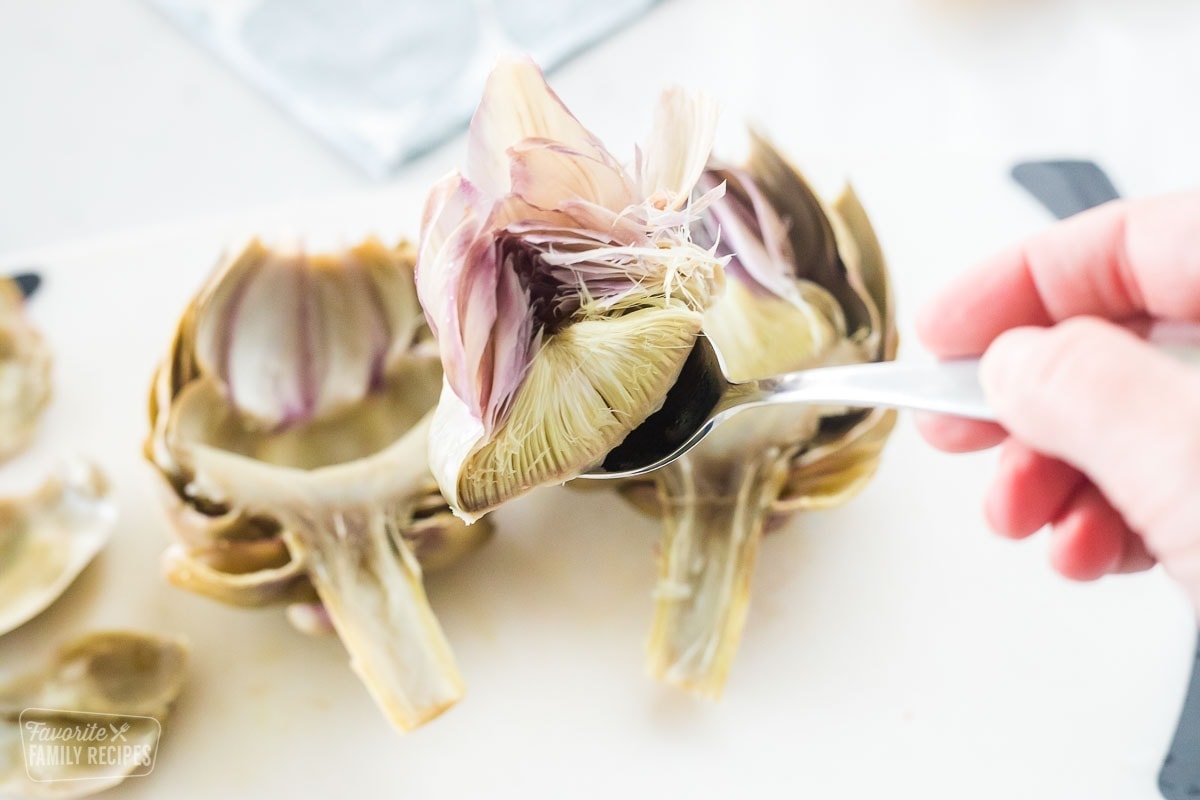 The thistle of an artichoke that has been removed with a spoon