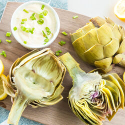 Cooked artichokes on a cutting board