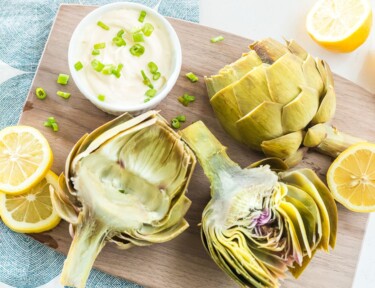 Cooked artichokes on a cutting board