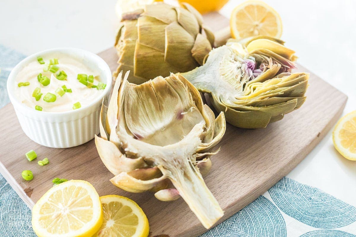 Cooked artichokes on a cutting board