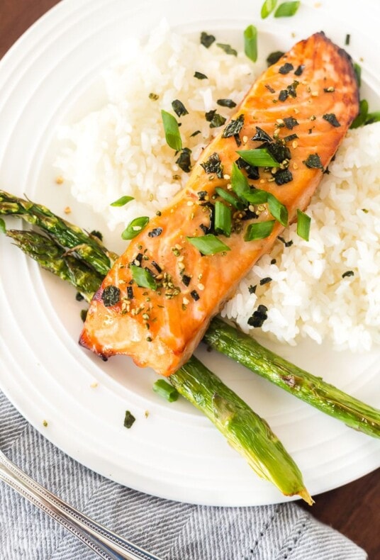A top view of miso salmon on a plate with rice and asparagus