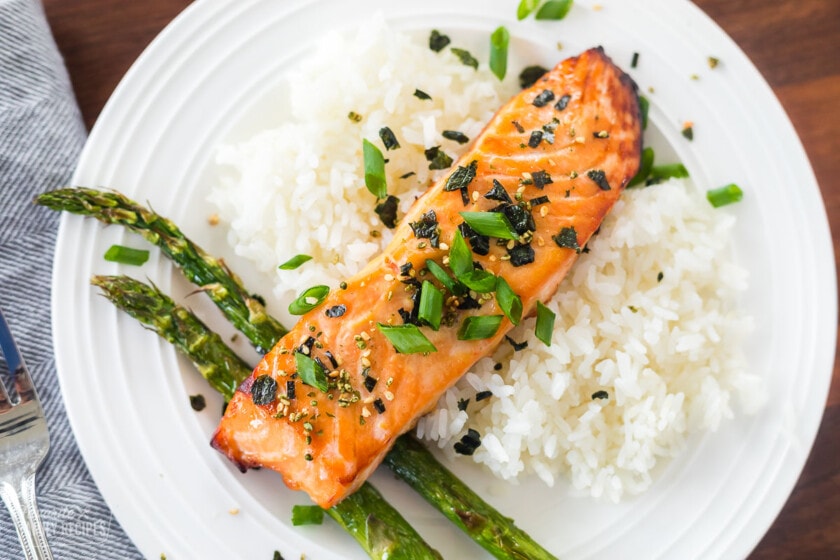 A top view of a plate of miso salmon, rice, and asparagus