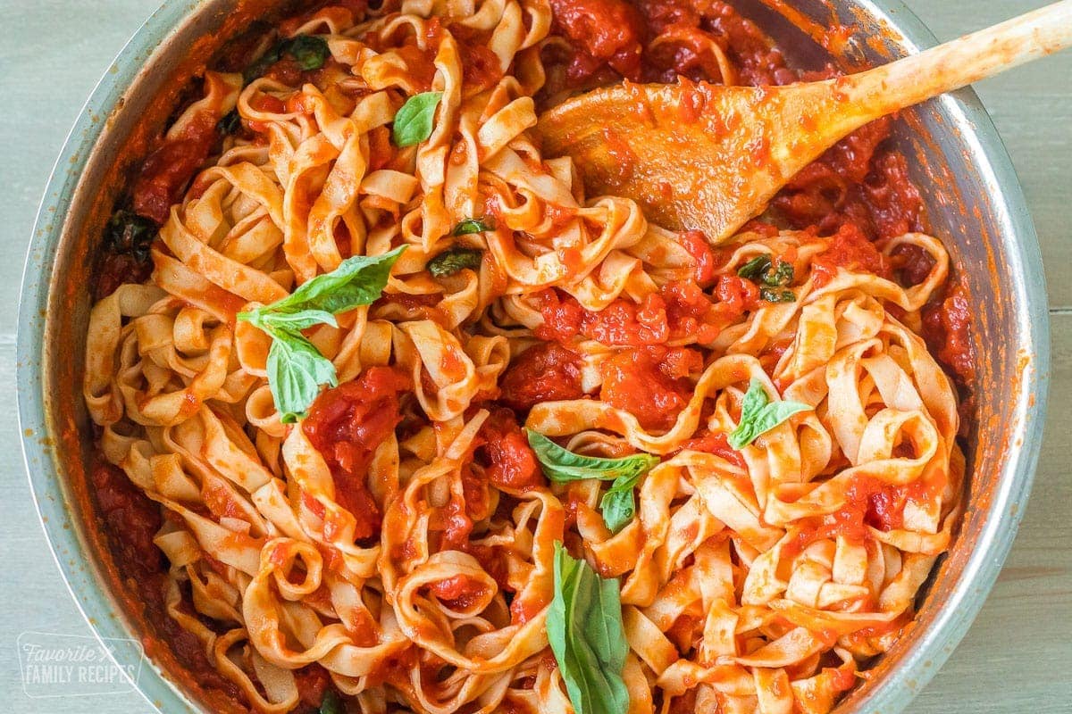 A pan with pasta noodles tossed with Pomodoro Sauce