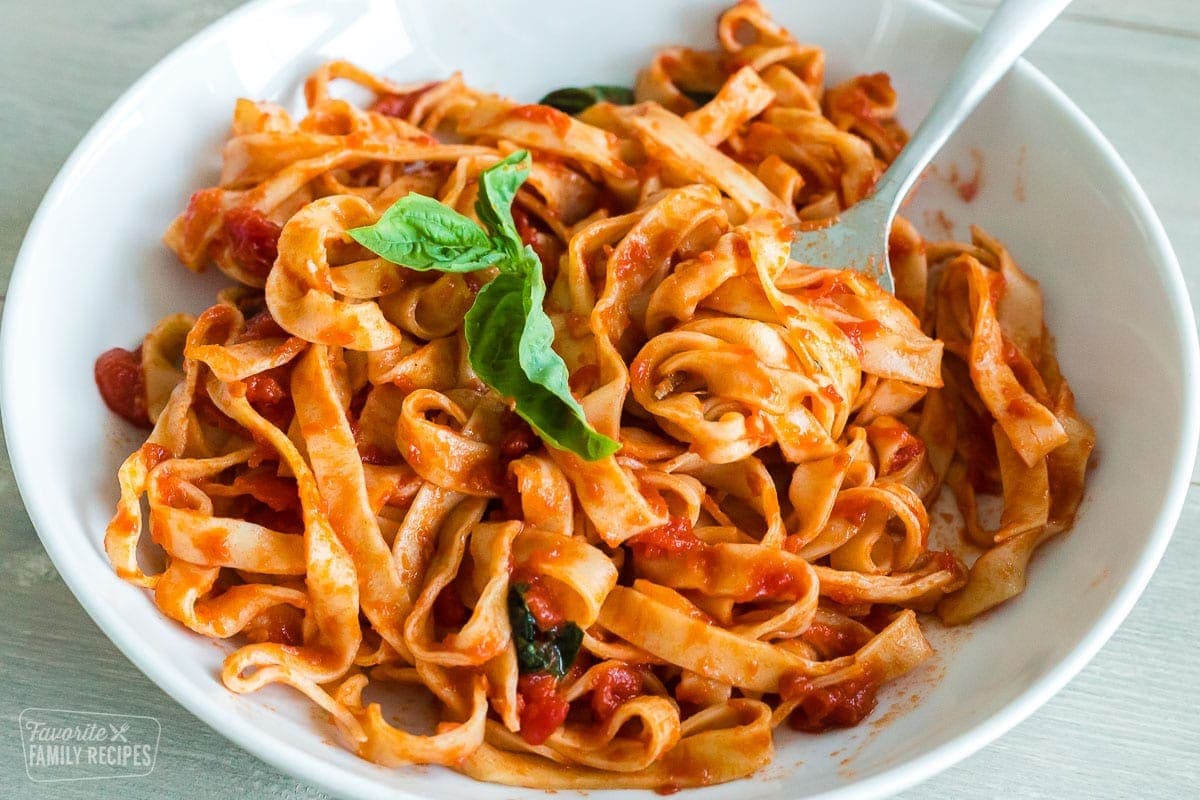 A plate of homemade pasta noodles tossed in pomodoro sauce.