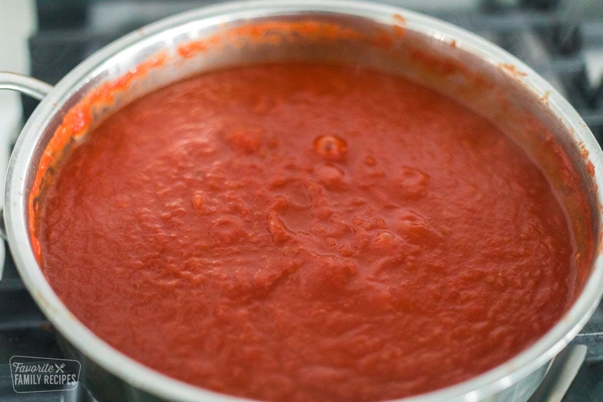 A pan of tomato sauce made from whole tomatoes that has been blended to be smooth