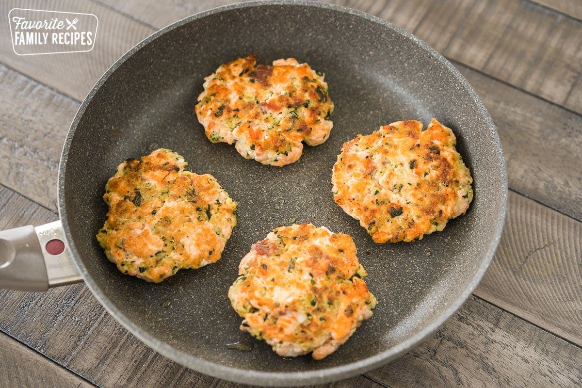 Salmon patties in a large skillet
