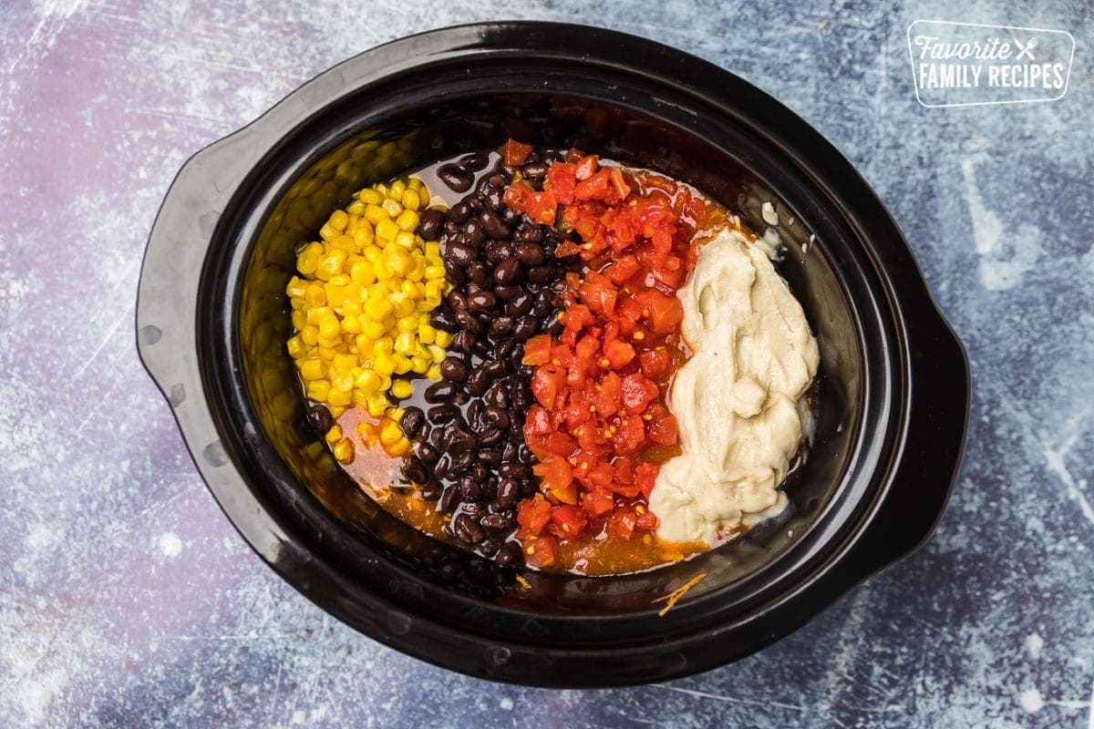 Corn, black beans, rotel, cream of chicken in slow cooker