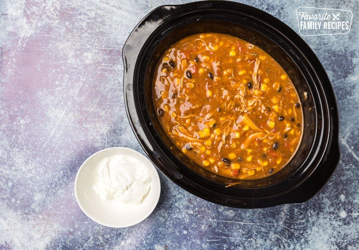 Cooked cafe zupas in crock pot with sour cream on side