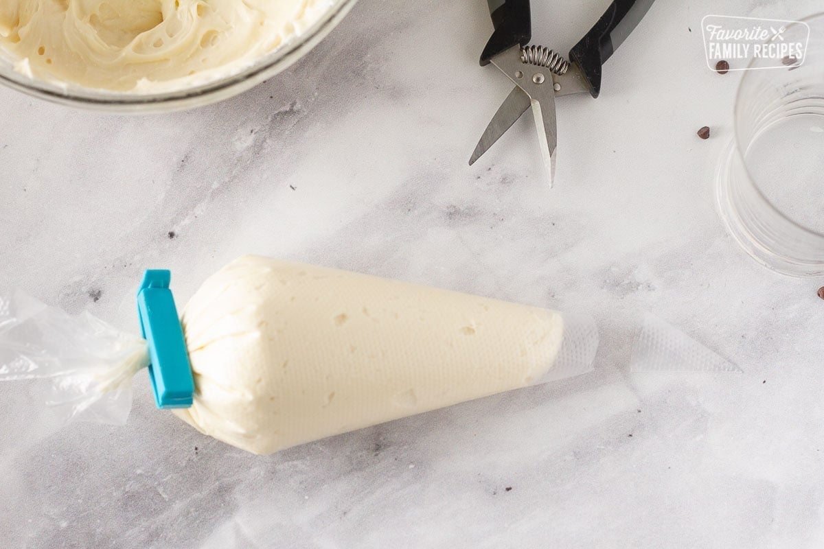 Piping bag with cream cheese frosting for the Chocolate Nothing Bundt Cake.