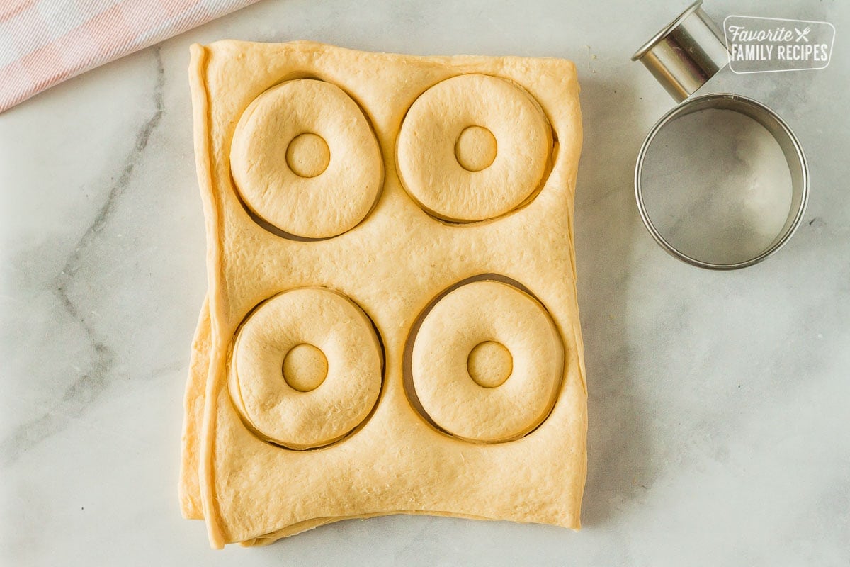 Cut outs of dough for cronuts.
