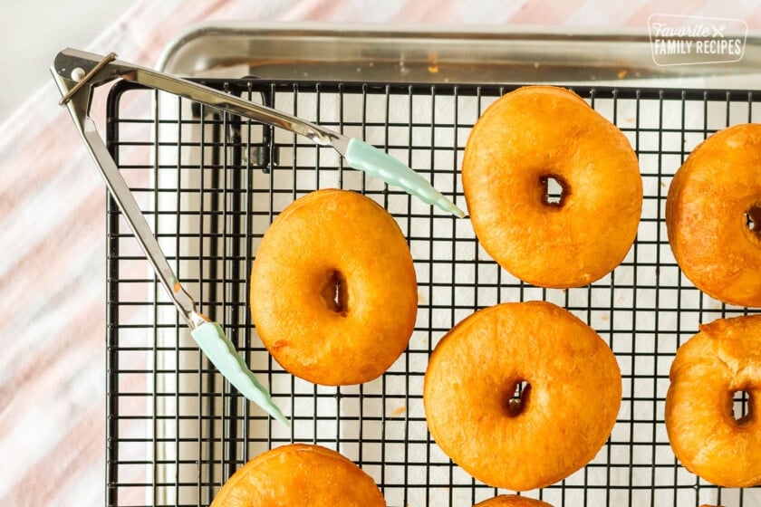 Plain cronuts cooling on a rack