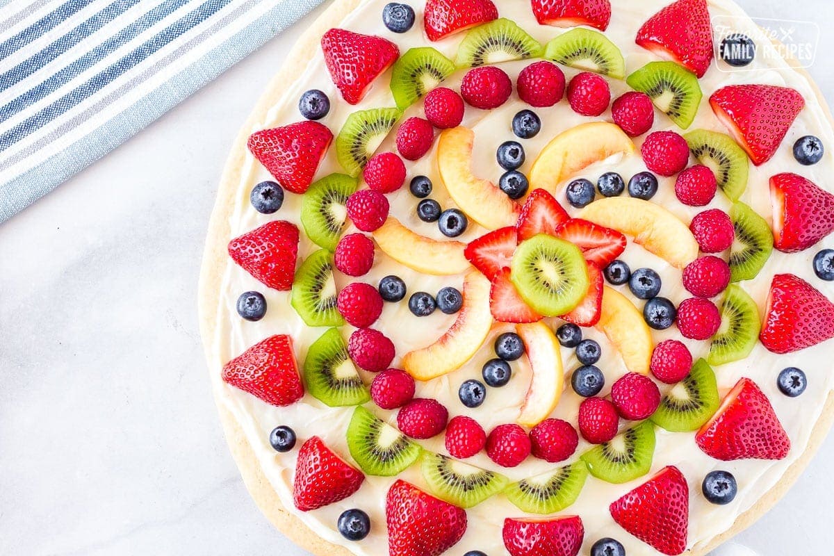 Whole easy fruit pizza with a colorful array of fresh fruit on top.