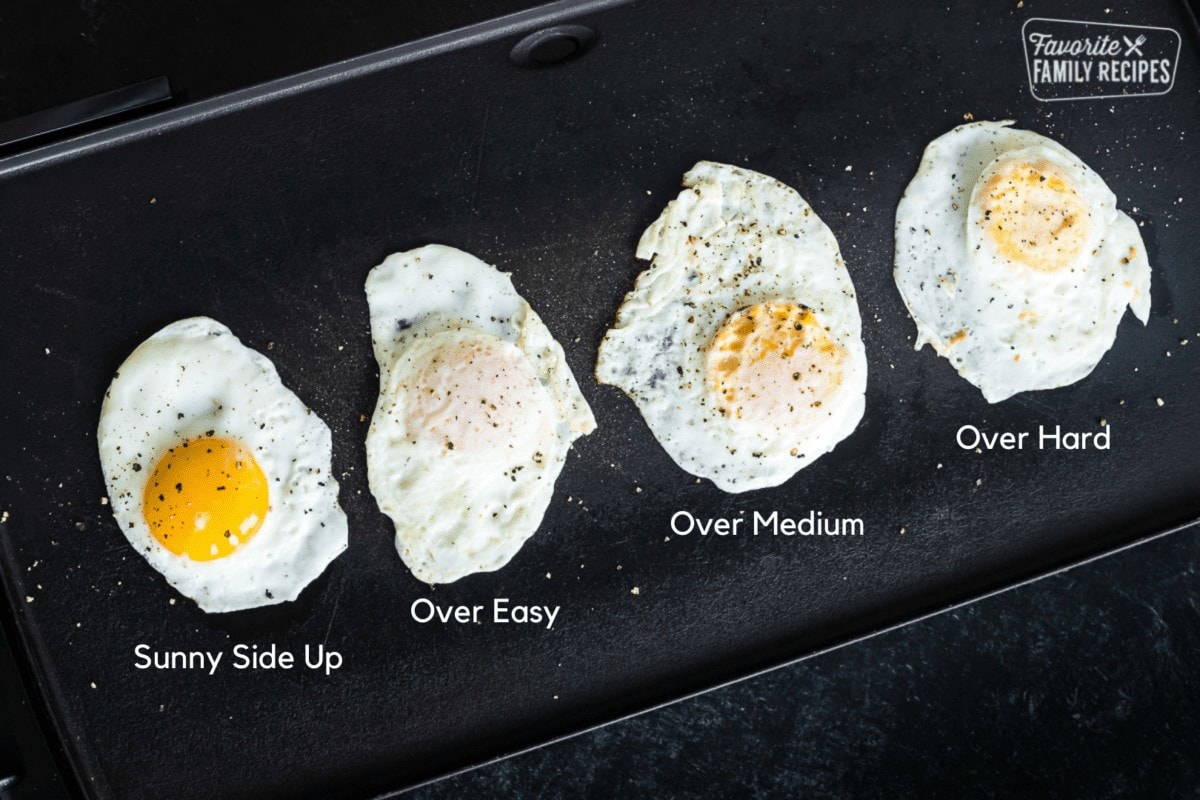 Fried eggs on a griddle cooked 4 different ways: sunny side up, over easy, over medium, and over hard