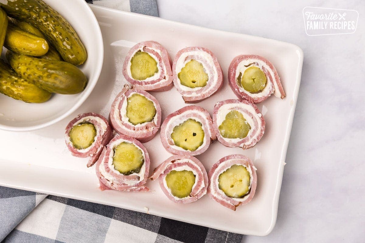 Ham roll ups on dish with pickles
