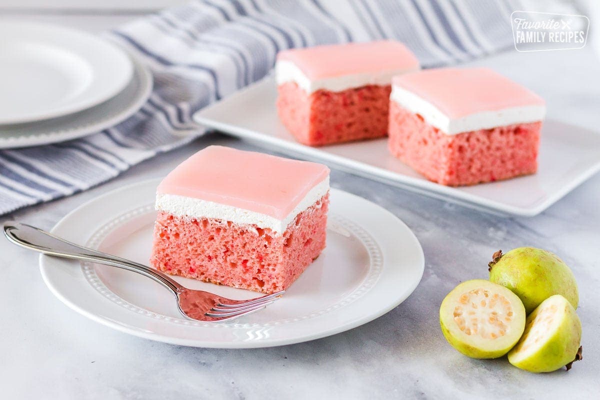 Fresh sliced guava next to a plate with a slice of Hawaiian guava cake.