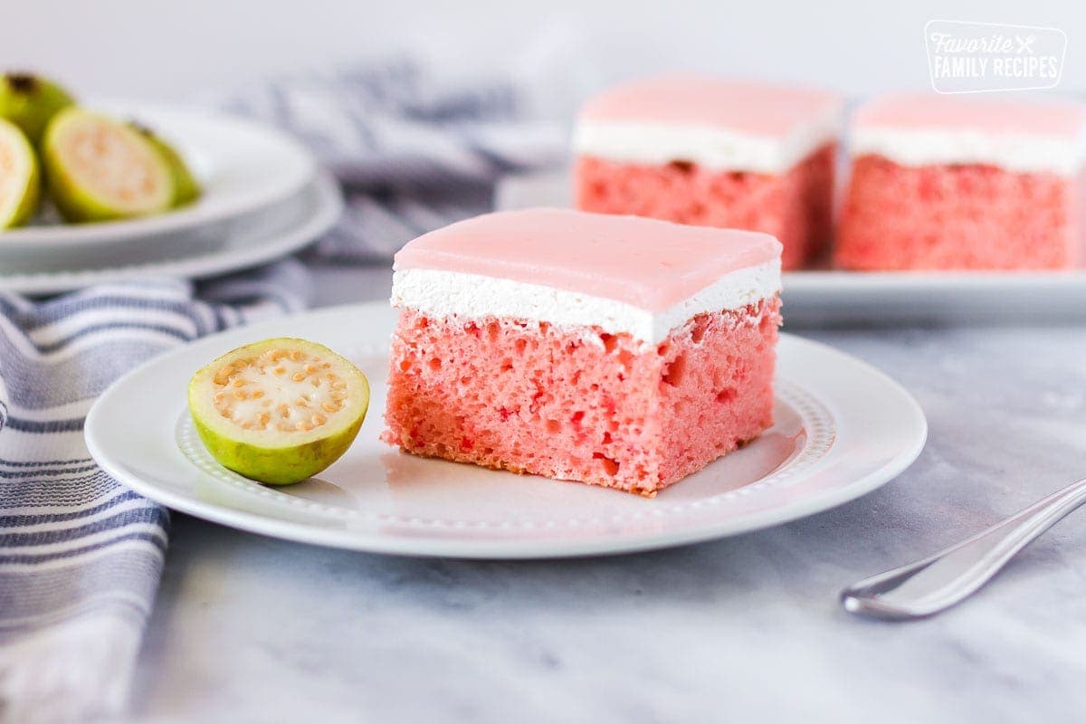 Slice of Hawaiian guava cake with a fresh sliced guava half on the side.