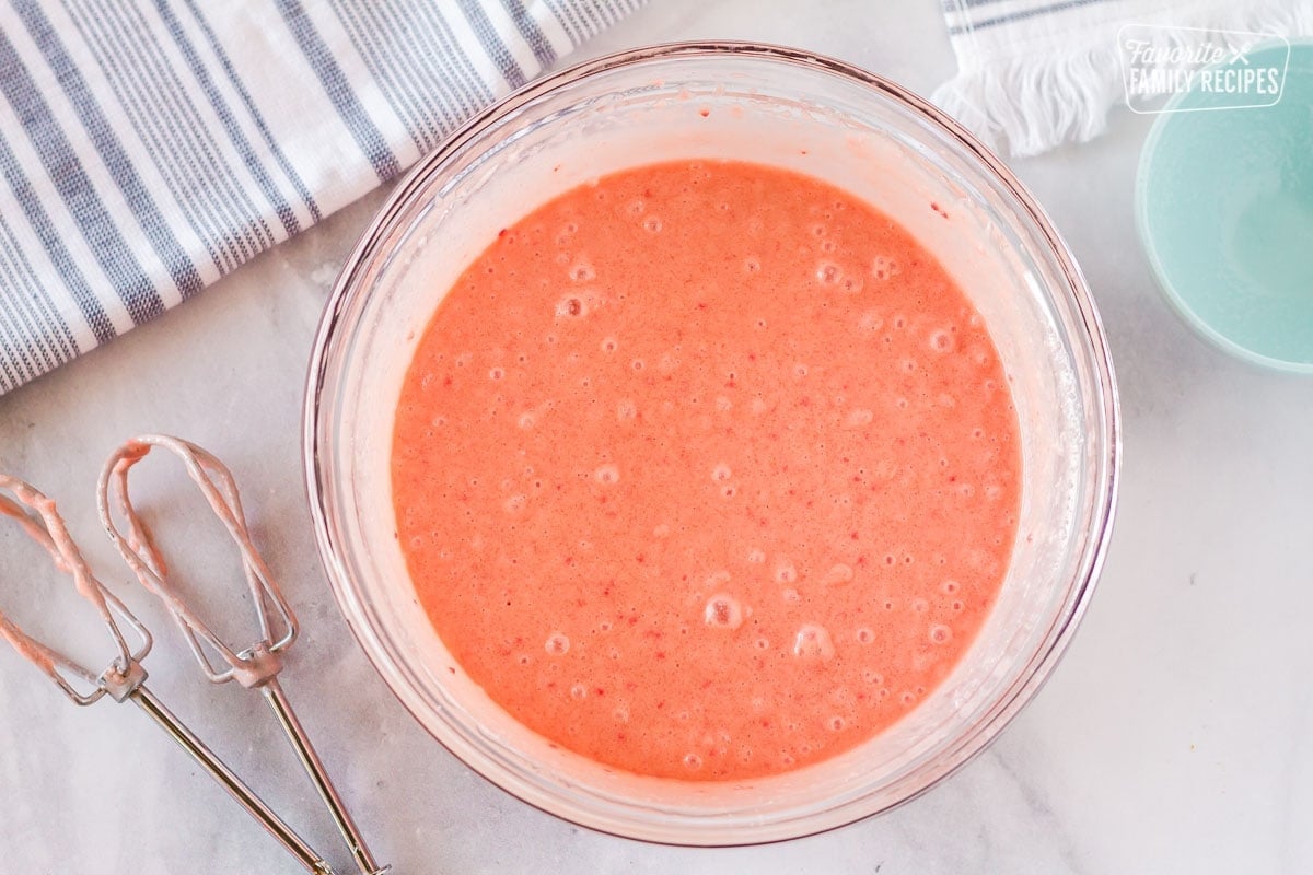 Bowl of prepared strawberry cake mix to make Hawaiian guava cake.