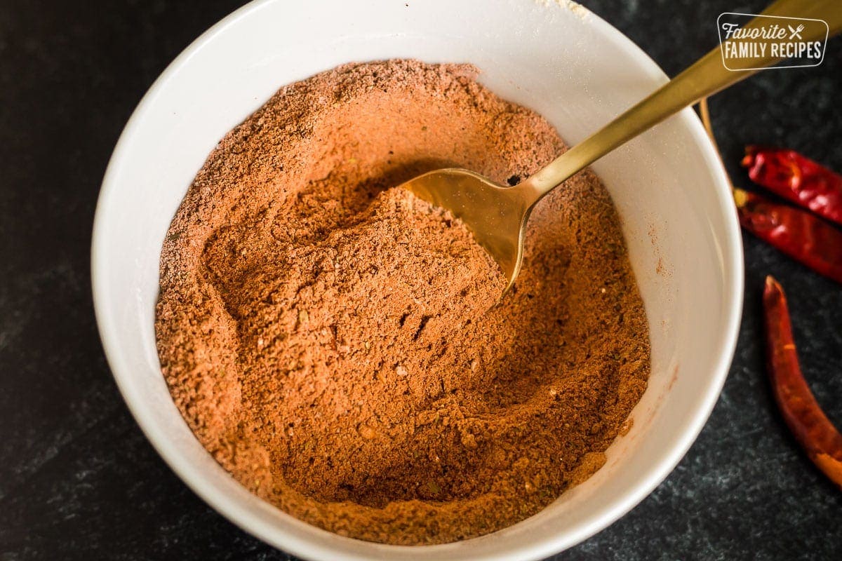 Homemade taco seasoning in a bowl with a golden spoon