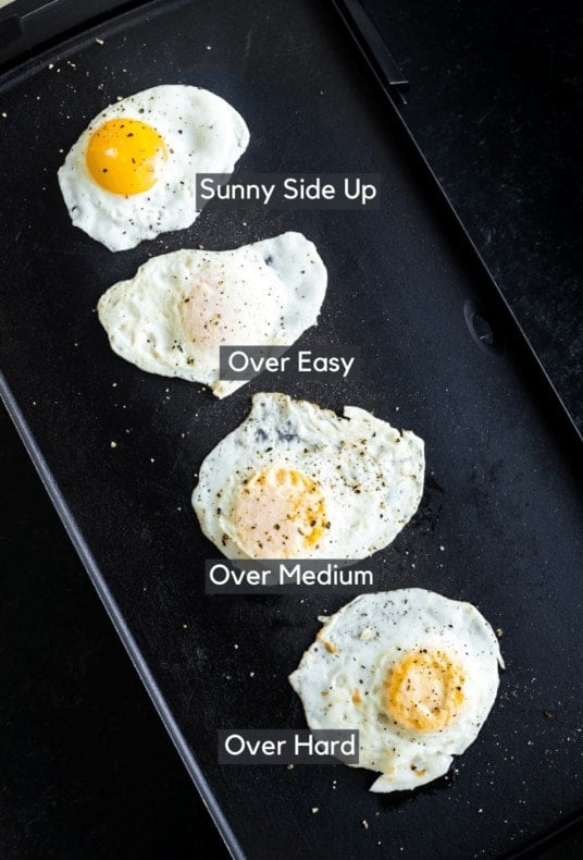 Fried eggs on a griddle cooked 4 different ways: sunny side up, over easy, over medium, and over hard