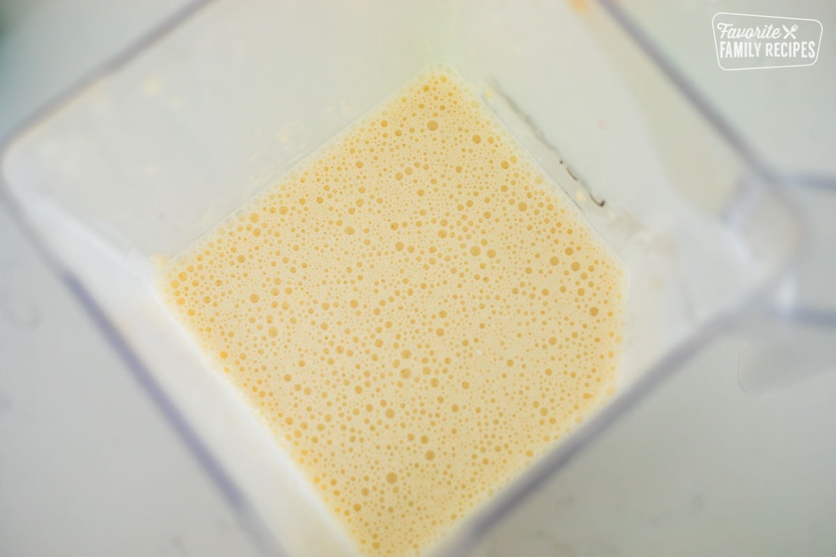 A top view of a blender with crepe batter that has been blended