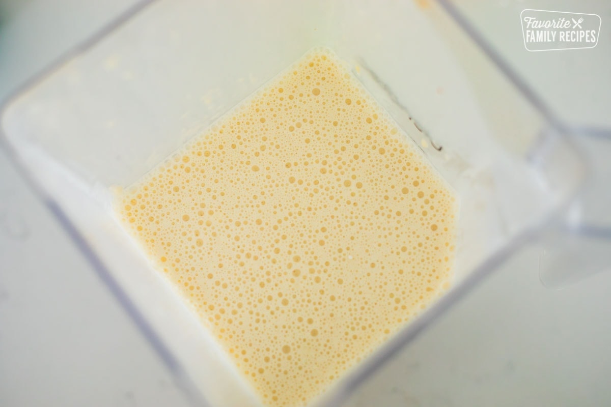 A top view of a blender with crepe batter that has been blended.