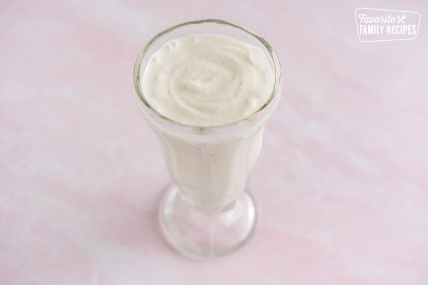 A tall glass full of vanilla shake