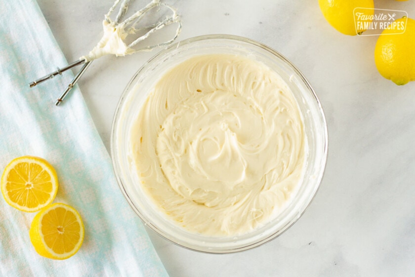 Frosting whipped in a bowl for lemon nothing bundt cake.